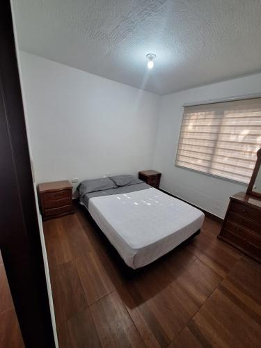 a bedroom with a bed in a room with a window at Apartamento Completo Socorro Santander 3 Habitaciones in Socorro