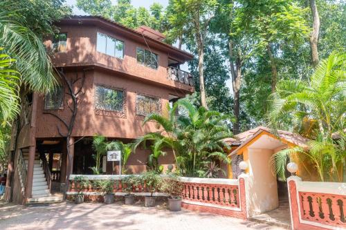 a house with a fence in front of it at Aayush Resort in Kālundri