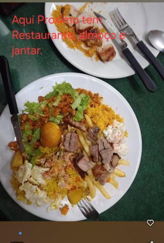 two plates of food on top of a table at Hospedagem Sousa Santos in Montes Claros