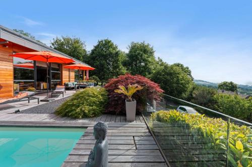 a house with a swimming pool and a patio at Exquisite 5-Bedroom Villa in Arzier for Families by GuestLee in Arzier