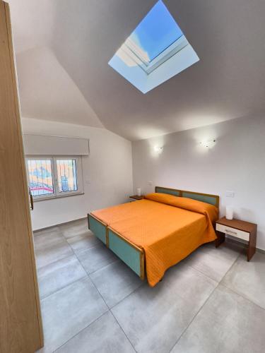 a bedroom with a bed and a skylight at Appartamento Mare e Relax in Bellaria-Igea Marina