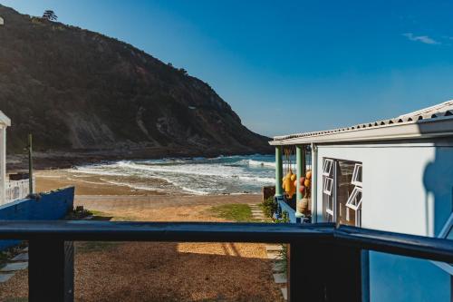 a view of the beach from a balcony of a house at Silver Spray Beach Accommodation in Victoria Bay
