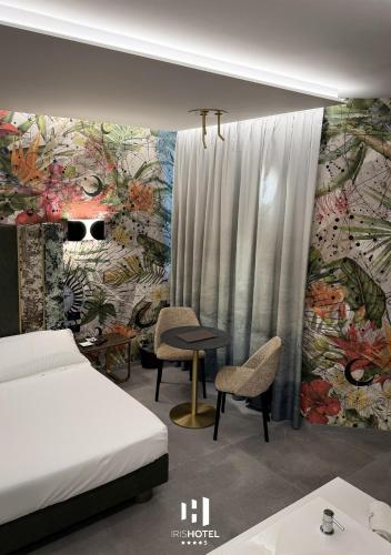 a bedroom with a bed and a wall with a mural at Iris Hotel in Erbusco
