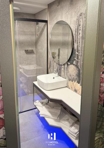 a bathroom with a sink and a mirror at Iris Hotel in Erbusco