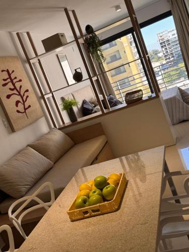 a basket of fruit on a table in a living room at Suit Chalet Santiago in Santiago del Estero