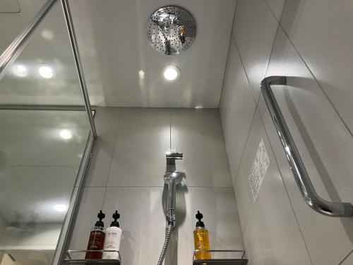 a bathroom with a shower and a shower head at Smile Hotel Hiroshima in Hiroshima