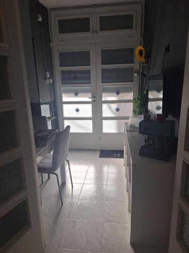 a kitchen with a door and a table and a desk at Girasole - Appartamento Centrale - Molfetta in Molfetta