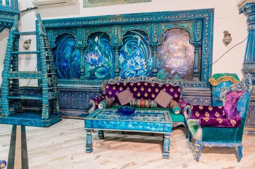 a room with a couch and two chairs in it at Aayush Resort in Kālundri