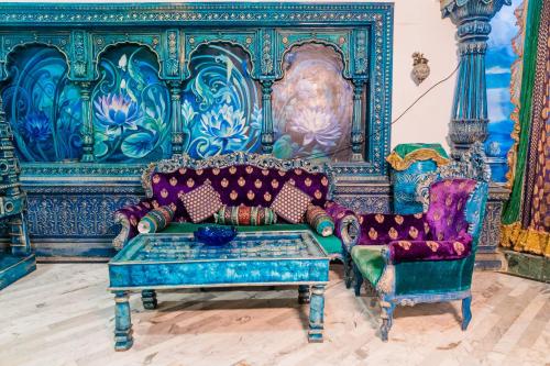 a living room with a couch and two chairs at Aayush Resort in Kālundri