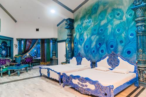 two beds in a room with a painting on the wall at Aayush Resort in Kālundri