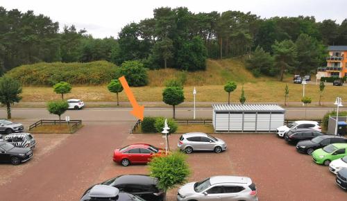 a group of cars parked in a parking lot at Fewo Wellenreiter Usedom 200 m zum Strand mit Balkon Parkplatz Wlan in Ostseebad Karlshagen