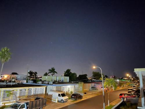 a parking lot with cars parked in front of a building at Bayamon Metro City View in Bayamon