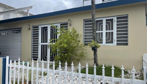 a white fence in front of a house at Bayamon Metro City View in Bayamon