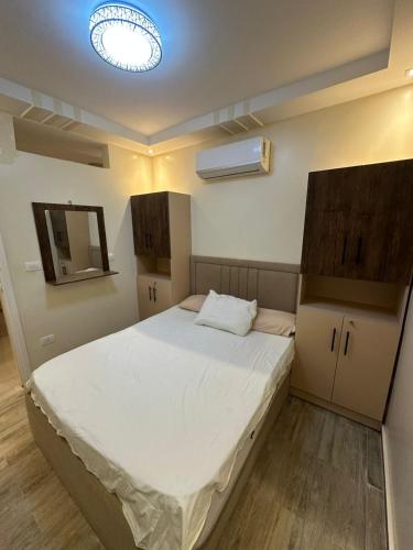 a bedroom with a large white bed in a room at Chalet rozza in El Alamein