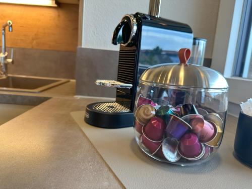 a glass jar filled with lots of beads on a counter at "FIVE" Premium Apartments Seekirchen - exklusive 4-Zi-Penthouse-Wohnung in Seekirchen am Wallersee