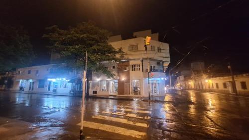 an empty city street at night with a traffic light at Duquesa Valentina Hotel in Salta