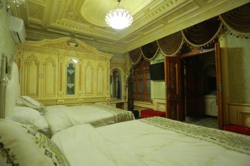 a bedroom with two beds and a chandelier at 梵雅民宿Vanya in Kashgar