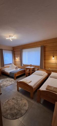 a large room with two beds and a table at U Bizioma in Murzasichle