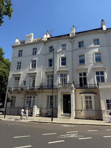 a white building on the corner of a street at Central London Budget Rooms in London