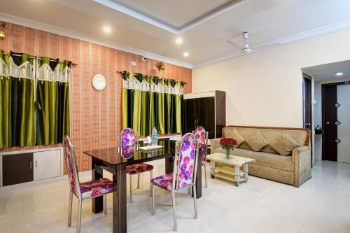 a living room with a table and chairs and a couch at Super Capital O New All In One Near City Centre Salt Lake in Kolkata