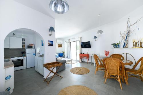 a kitchen and living room with a table and chairs at Anchor Villa in Troulos