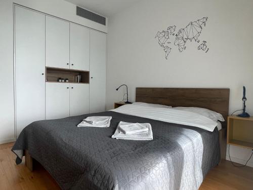 a bedroom with a bed with two towels on it at SAG Sky park castle wiev Free parking Free wifi in Bratislava