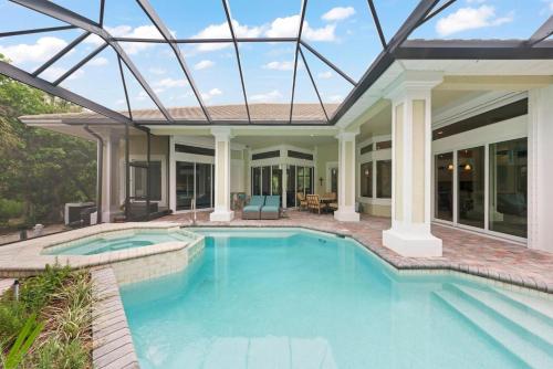 a house with a swimming pool with a glass roof at Sanctuary Chateau in Sanibel