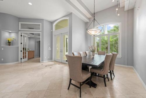 a dining room with a table and chairs at Sanctuary Chateau in Sanibel