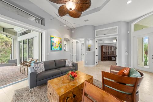 a living room with a couch and a table at Sanctuary Chateau in Sanibel
