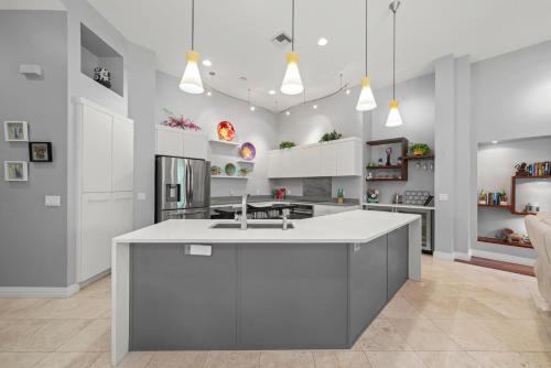 a kitchen with a white island in a room at Sanctuary Chateau in Sanibel