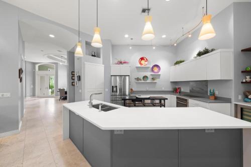 a kitchen with white cabinets and a white counter top at Sanctuary Chateau in Sanibel