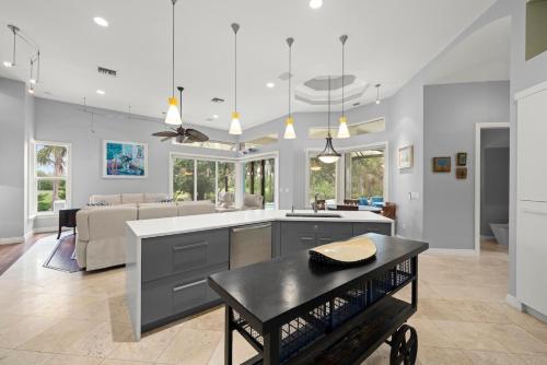 a kitchen and living room with a table and a couch at Sanctuary Chateau in Sanibel