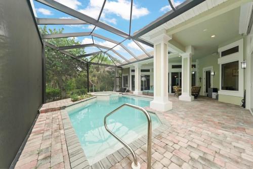 an indoor swimming pool with a glass roof at Sanctuary Chateau in Sanibel