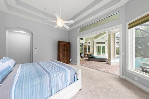 a bedroom with a bed and a ceiling fan at Sanctuary Chateau in Sanibel