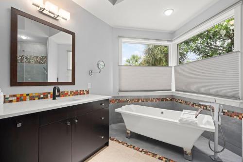 a bathroom with a large tub and a large window at Sanctuary Chateau in Sanibel