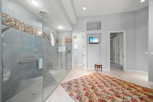 a bathroom with a shower and a rug at Sanctuary Chateau in Sanibel