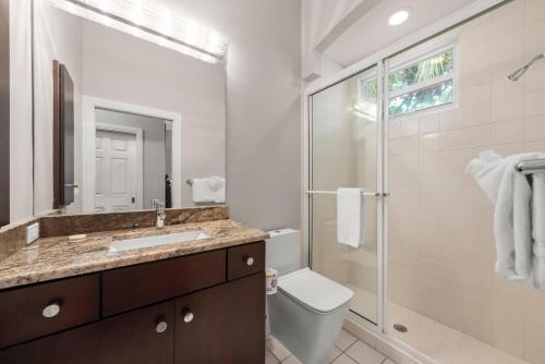 a bathroom with a toilet and a shower and a sink at Sanctuary Chateau in Sanibel