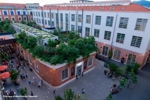 an overhead view of the courtyard of a building with plants at NEW OPENING 2025 aparto Florence Manifattura in Florence