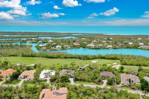 an aerial view of a resort with a golf course and a lake at Sanctuary Chateau in Sanibel