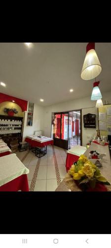 a dining room with tables and chairs and a room with tablesktop at vecchio west in Agerola