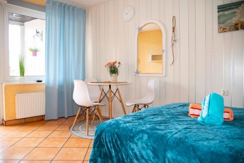 a bedroom with a bed and a table and chairs at Cała NAPRZÓD in Władysławowo