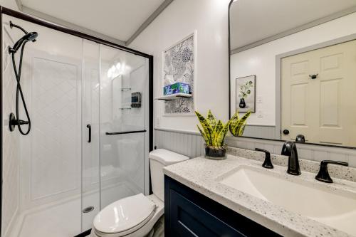 a bathroom with a toilet and a sink and a shower at Riverfront Retreat with Near Boat Launch in Nineveh! 