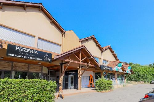 a building with a sign on the front of it at Le studio de Gargantua in Dardilly