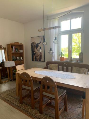 a dining room with a table and two chairs at Große Ferienwohnung in einer Villa im Grünen in Neustadt am Kulm