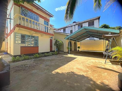 a large building with a canopy in front of it at Homely apartments 4 in Kisumu