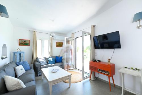 a living room with a couch and a tv at Anchor Villa in Troulos