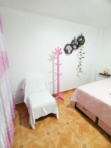 a room with two beds and a cross on the wall at Hostel AyJ Familia Round Trip Airport Tr4nsfer Included in Lima