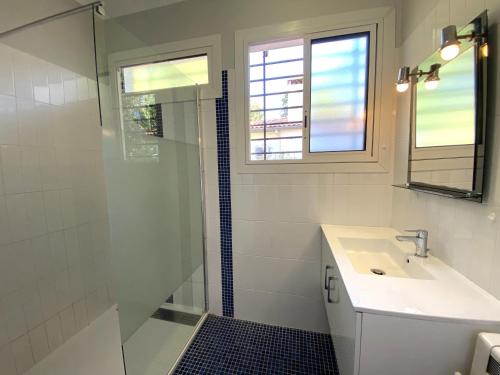 ein Badezimmer mit Waschbecken und Glasdusche in der Unterkunft PINSONS maison familiale proche plage in Pyla-sur-Mer