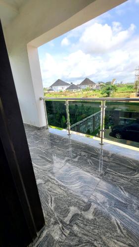 a room with a large window with a view of a street at The Marble Hotel and Apartments in Uyo