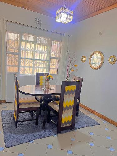 a dining room with a table and chairs at Homely apartments 4 in Kisumu